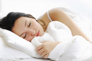 Beautiful woman lying and sleep on the snowy bed